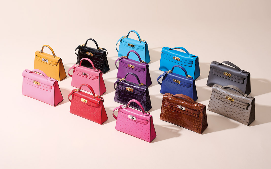 An array of colorful, stylish handbags displayed on a light background.