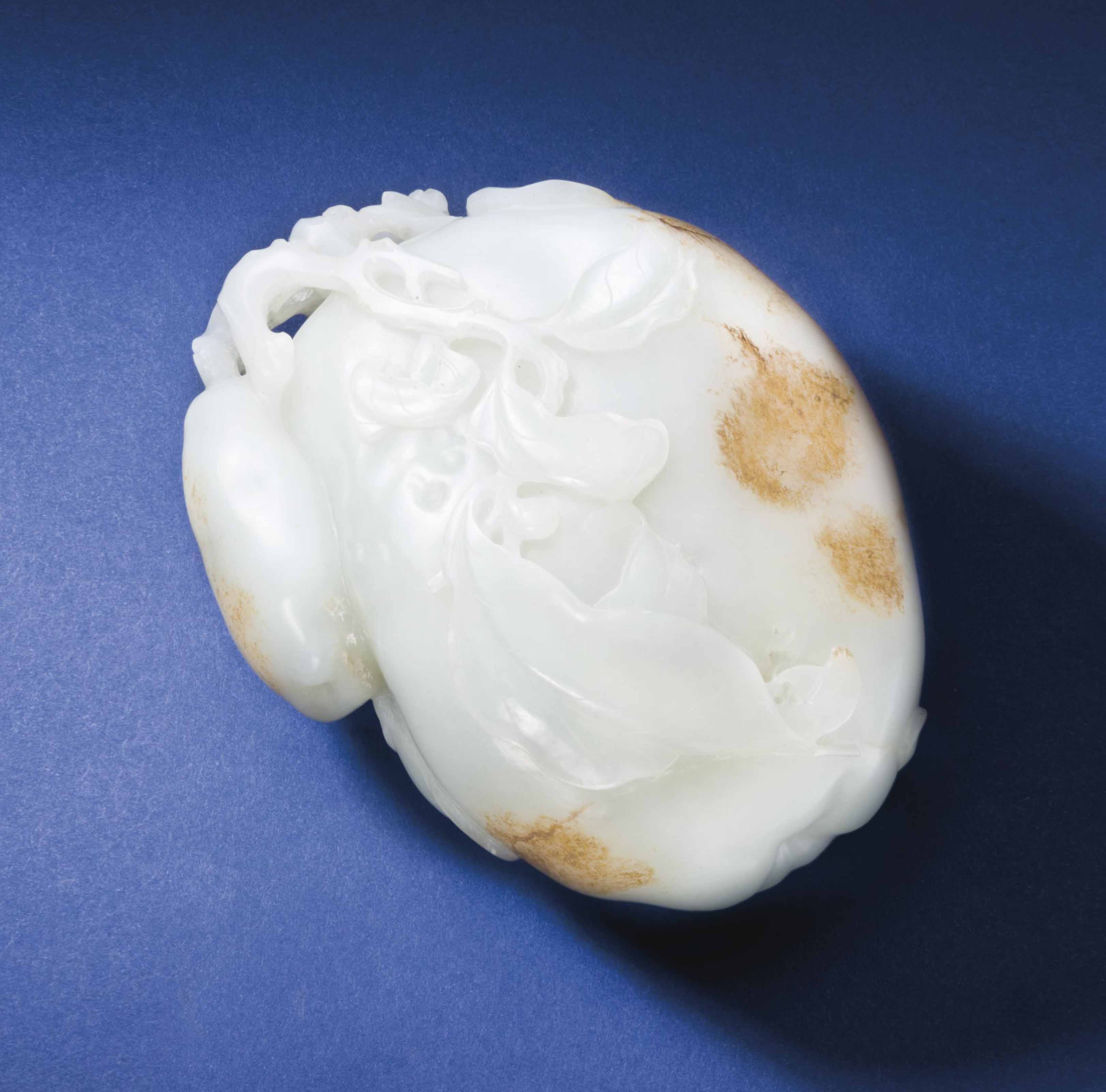a large well-carved pale greenish-white jade carving of quince